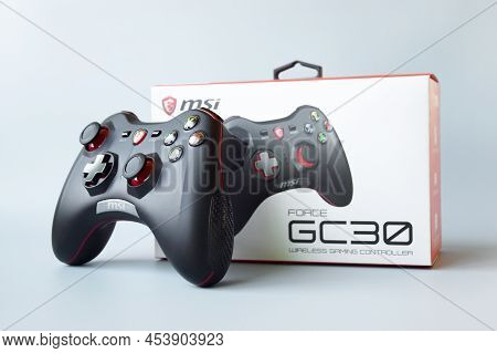 Two Msi Joystick Gaming Controller On Light Blue Background.