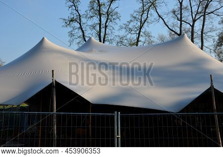 White Tarpaulin Taut, Shading From The Sun And Rain Over The Terrace Of The Restaurant, On The Playg
