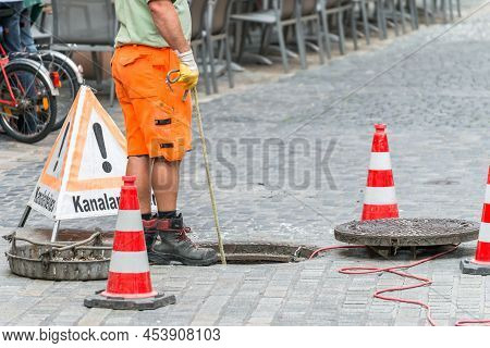 Street Works On Sewer Channel  With Warn Sign In German Words For Channel Works
