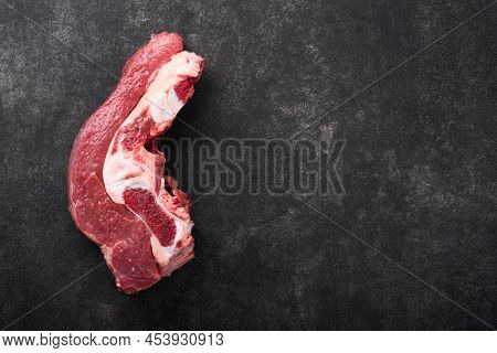 Raw Beef Meat. Rough Piece Of Meat On Bone For Roast Or Soup With Salt, Pepper, Thyme And Rosemary O
