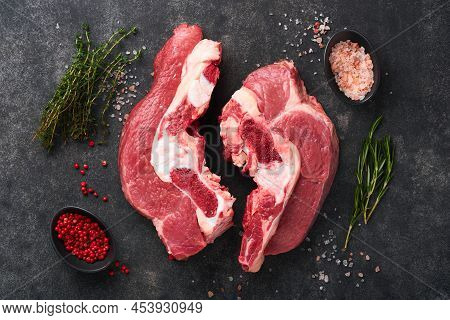 Raw Beef Meat. Rough Piece Of Meat On Bone For Roast Or Soup With Salt, Pepper, Thyme And Rosemary O