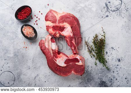 Raw Beef Meat. Rough Piece Of Meat On Bone For Roast Or Soup With Salt, Pepper, Thyme And Rosemary O