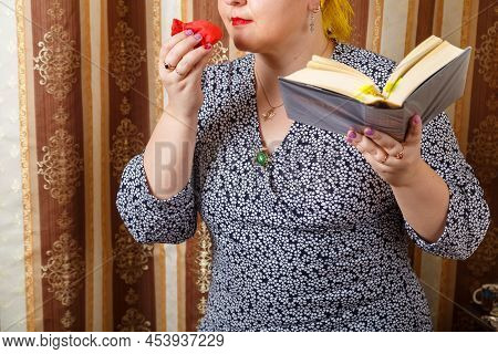 A Jewish Woman Sniffs Bsamim Spices After Shabbat While Holding A Siddur. Horizontal Photo