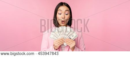 Finance, Microcredit And People Concept. Happy Smiling Asian Businesswoman Showing Dollars Money, St