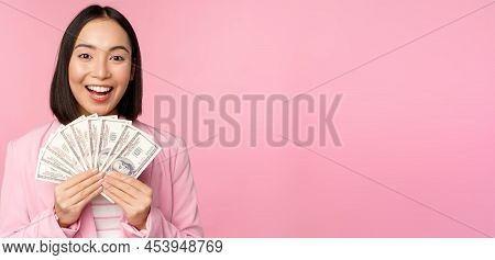 Finance, Microcredit And People Concept. Happy Smiling Asian Businesswoman Showing Dollars Money, St