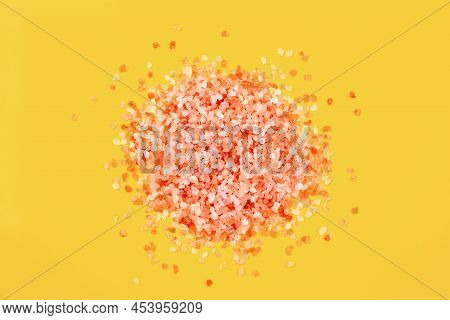 Pink Himalayan Salt Crystals Heap Closeup On Bright Yellow Background
