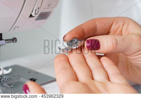 Seamstress Holds Sewing Machine Parts In Hands. Presser Foot Accessories In Tailor Hand. Dressmaker 