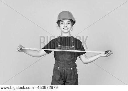 Kid Repairing Home. Happy Childhood. Self-retracting Metal Tape Measure. Girl Using A Measuring Tape