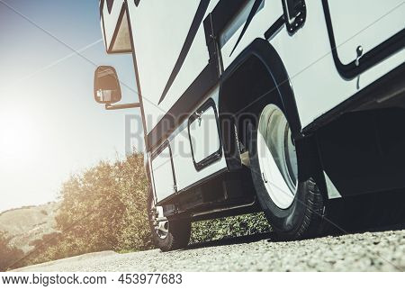 Recreational Class C Motorhome Vehicle On The Side Of A Road. Summer Family Rving Theme. Road Trip C