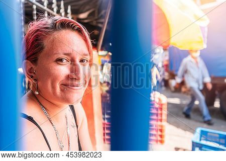 Portrait Of A White Latin Woman With A Modern Haircut With Piercings On Her Lips And Subtle Tattoos 