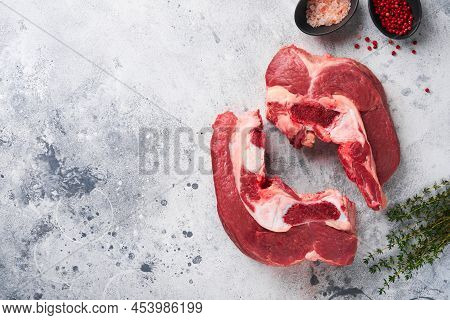 Raw Beef Meat. Rough Piece Of Meat On Bone For Roast Or Soup With Salt, Pepper, Thyme And Rosemary O