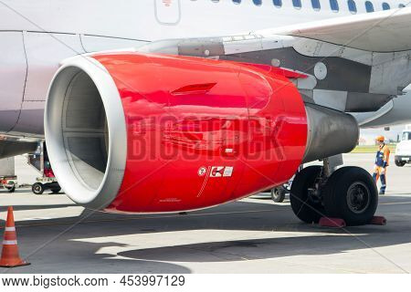 Red Engine Of A Passenger Aircraft. Closeup View.