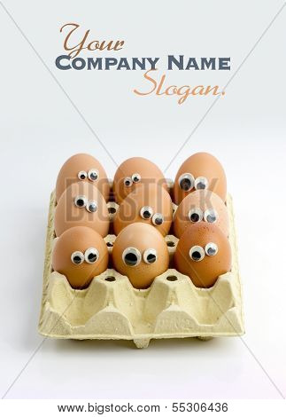 A group of eggs in a box with funny eyes 