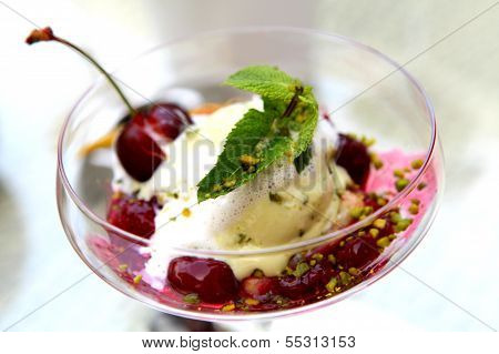 Ice cream with cherries in a glass