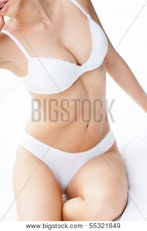Body of a halfnaked woman in underwear, isolated on white background