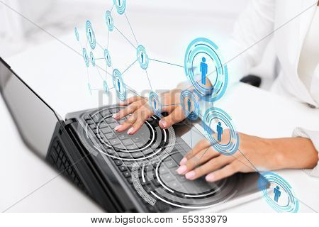 office, business, technology, networking and internet concept - businesswoman using her laptop computer