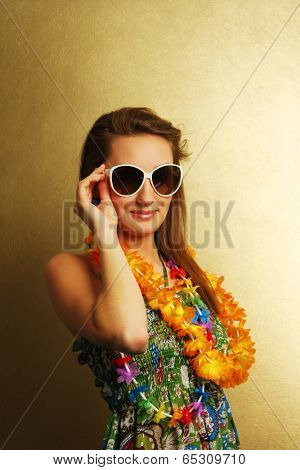 Girl with sunglesses and hawaiian wreath