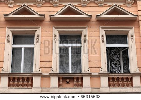 Three Window Of Brown Building