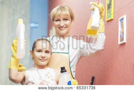 Mother And Daughter Doing Tidy Up Together