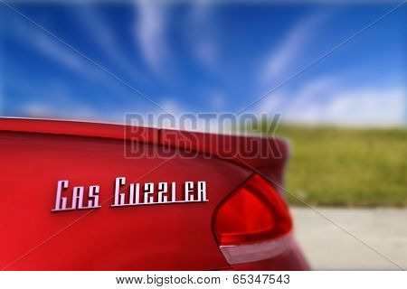 Gas guzzler - energy concept showing the rear of a car with 