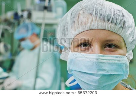 Female surgeon in uniform in front of cardiac surgery operation room at clinic
