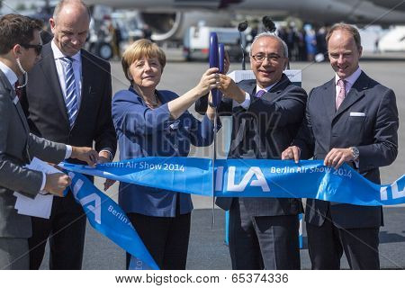 BERLIN, GERMANY - MAY 20, 2014: German Chancellor Angela Merkel, Turkish Minister of transport Lutfi Elvan and CEO Mr Christian (C.-R.) open up the International aviation and space exhibition ILA.