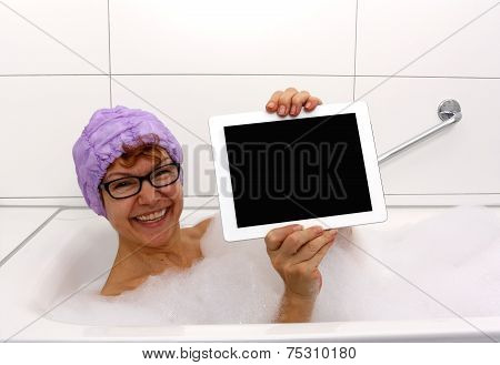 Enthusiastic Mature Woman In Bathtub With Tablet Computers