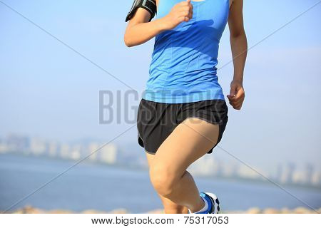 Runner athlete running at seaside city