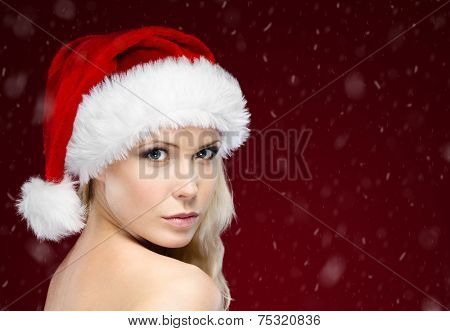 Pretty woman in Christmas cap, isolated on purple