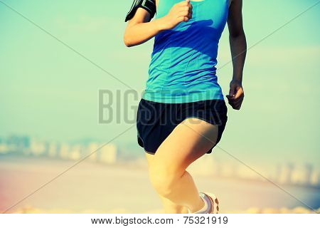 Runner athlete running at seaside city
