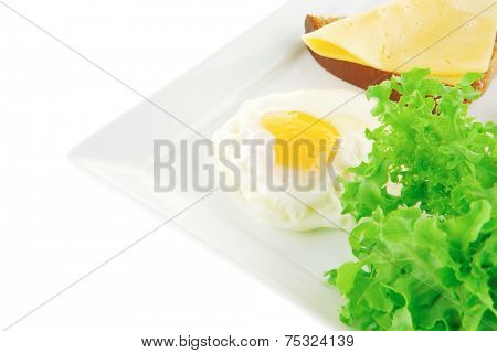green lettuce salad and fried eggs on white