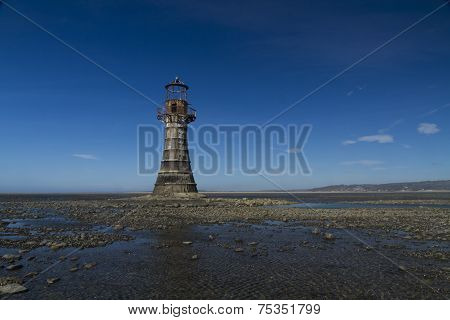 Ruined Derelict Lighthouse, Space To Top Right. Whiteford Sands, Gower Peninsula, South Wales. Blue