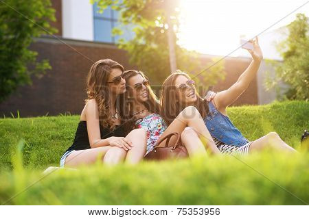 Selfie Photo.3 pretty woman enjoying the nice weather on the grass