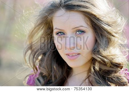 young beautiful woman portrait on field in summer