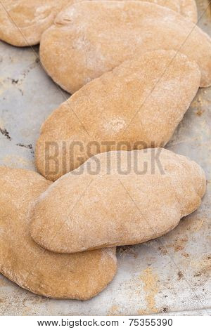 Loaves of traditional Egyptian homemade brown pita bread, fresh from the oven. called aish baladi