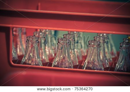 Red Plastic Crate With Empty Glass Bottles