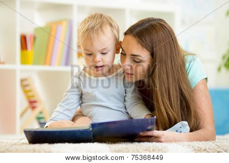 mother reads a book to kid at home