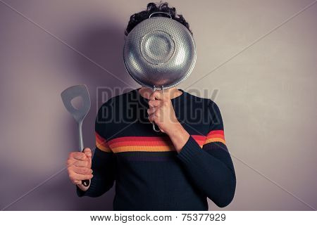Young Man Hiding Behind Collander