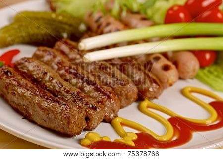 Grilled sausages with vegetables on a white plate