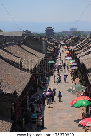 people are walking on the pedestrian street in Pingyao