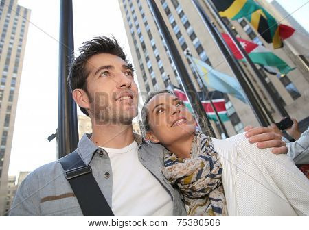 Couple standing by the Rockfeller center in New York City