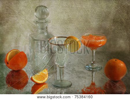Still-life with an orange and a cocktail in a beautiful wine glass