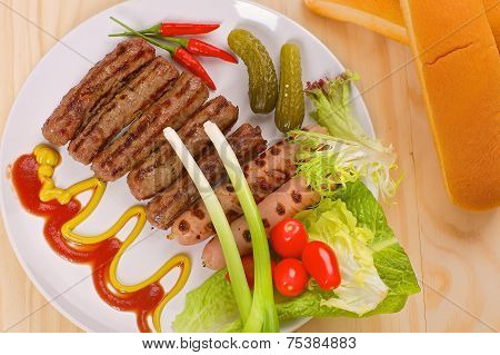 Grilled sausages with vegetables on a white plate