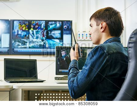 security guard watching video monitoring surveillance security system