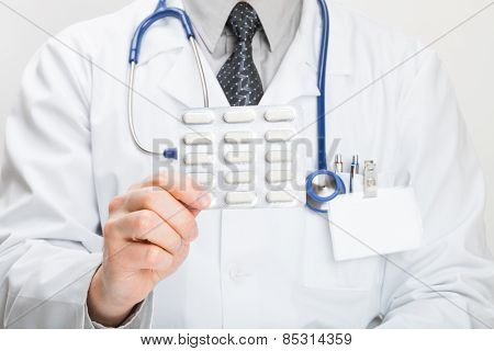 Doctor Holdling Pills In Hand