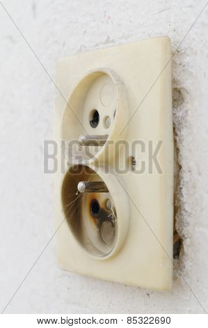 Old Burnt Plug In A Wall