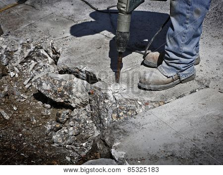 Man drilling cement concrete road