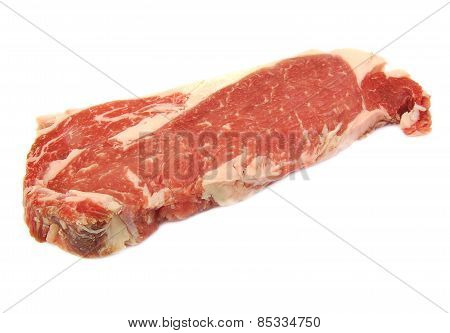 Single uncooked raw entrecote steak on a white background