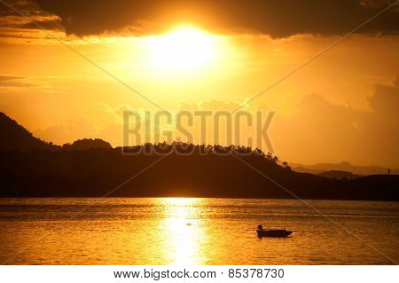 Traditional Fisherman Long Tailed Boat In Koh Phitak Island, Thailand At Sunset.