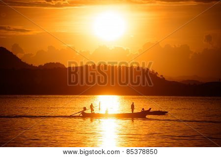 Traditional Fisherman Long Tailed Boat In Koh Phitak Island, Thailand At Sunset.
